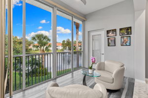 Sunlit sitting area overlooking peaceful lake and fountain views