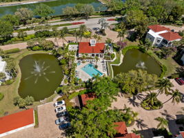 Resort-style pool and clubhouse surrounded by lakes
