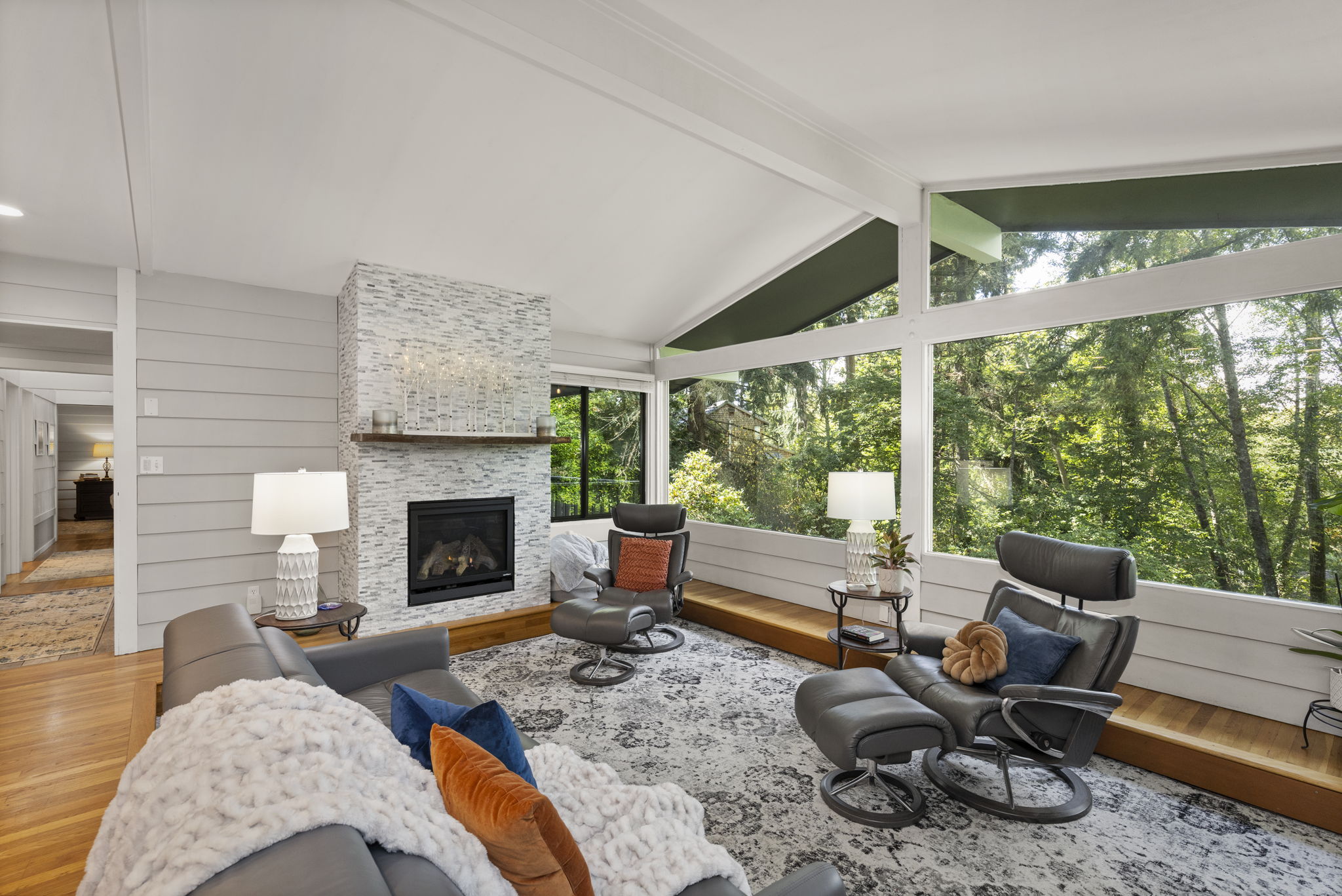 Wall-to-wall windows flooding the living room with natural light