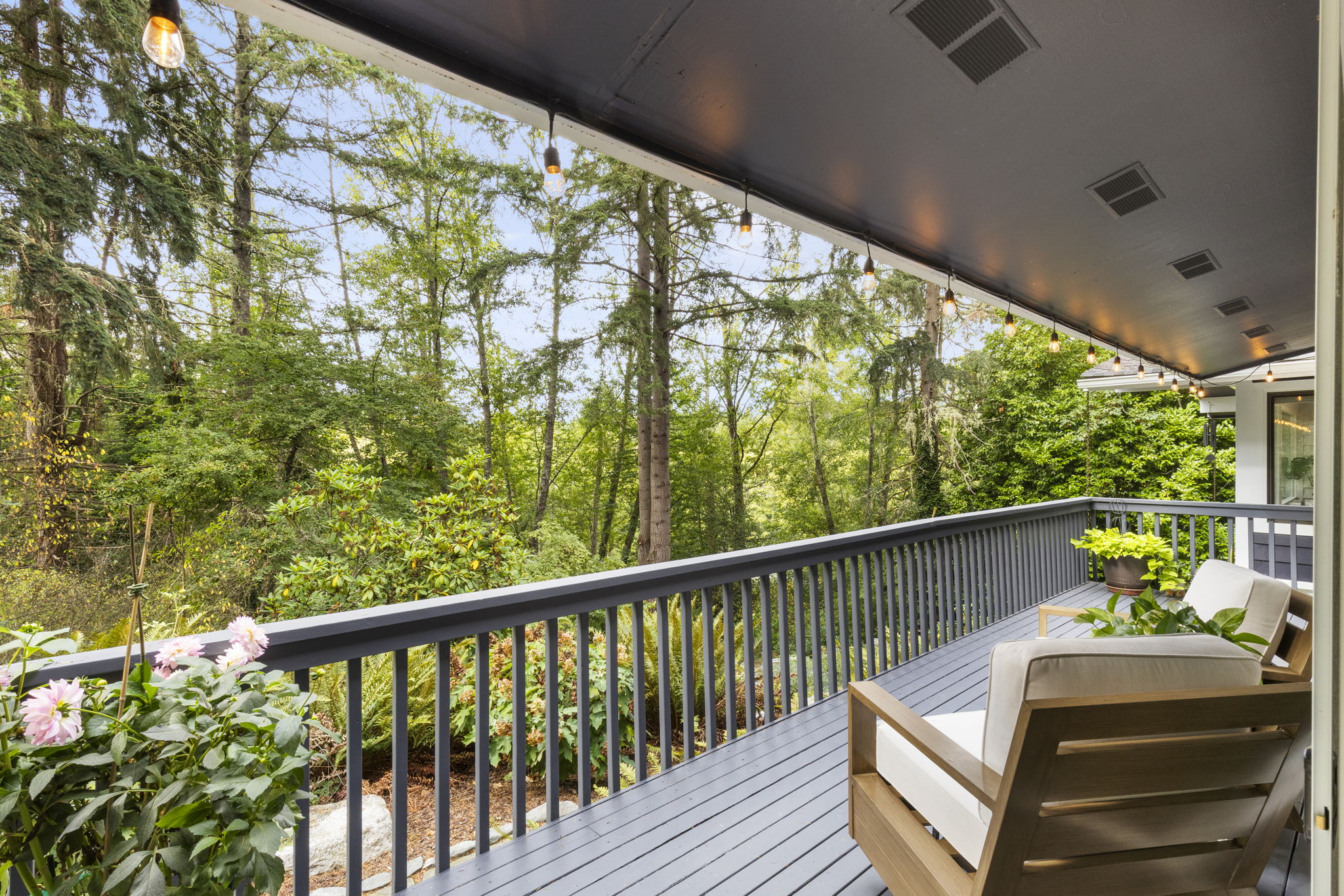 A tranquil garden-view deck extends from the primary suite