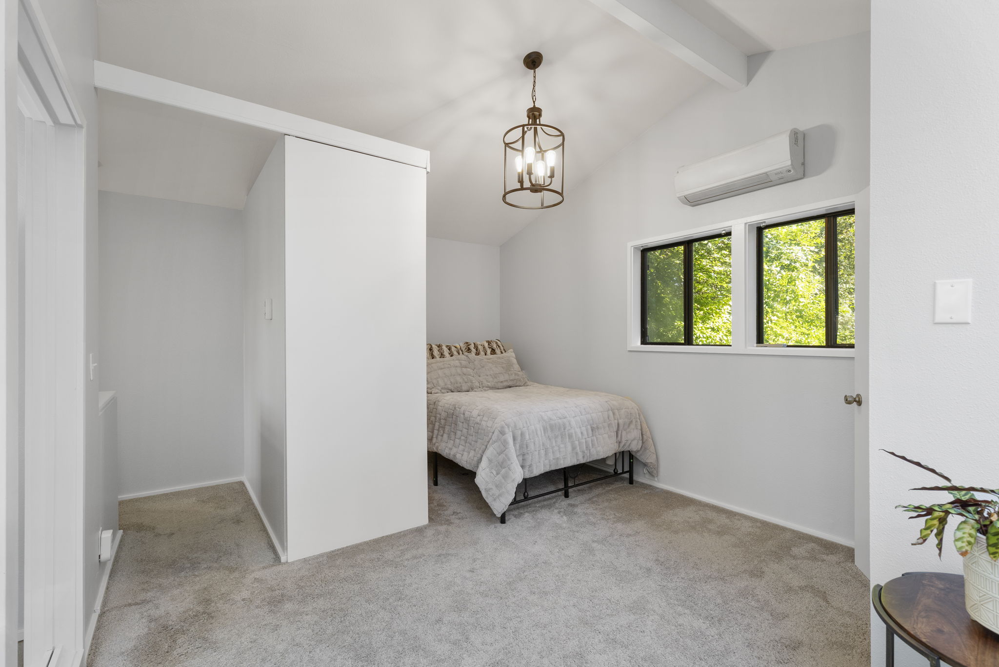 Cozy upper level bedroom with natural light