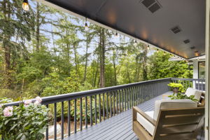 A tranquil garden-view deck extends from the primary suite