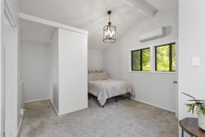 Cozy upper level bedroom with natural light