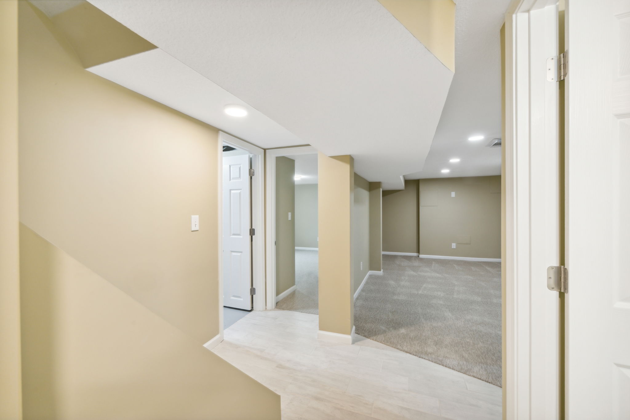 Entering the lower level with third bedroom, separate living area, and bath!