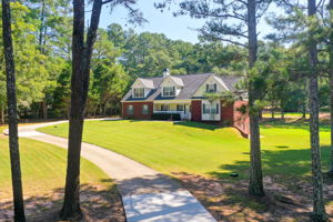 1 Aerial Exterior Front A w Yard + Driveway