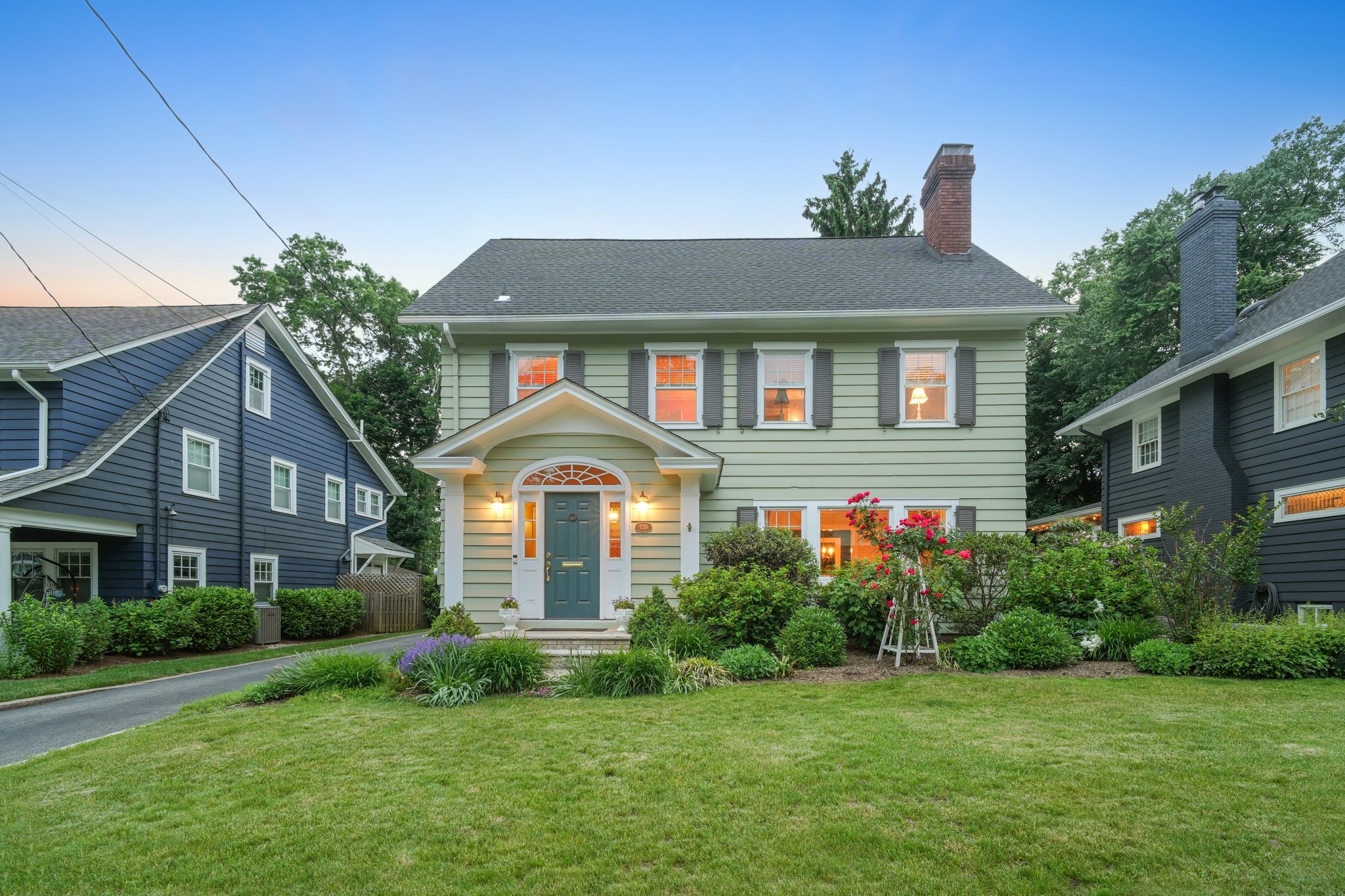 Warm light glowing from within, gardens in bloom, and timeless architecture that feels as welcoming today as it did nearly a century ago. This is where coming home feels especially good.