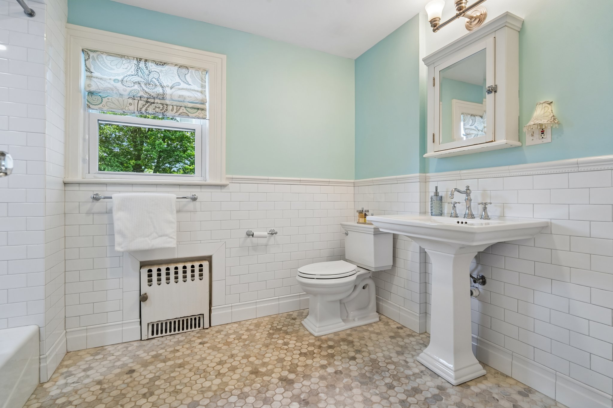 The 2nd floor hall bath is thoughtfully updated with classic finishes and serves the additional bedrooms with ease and style.