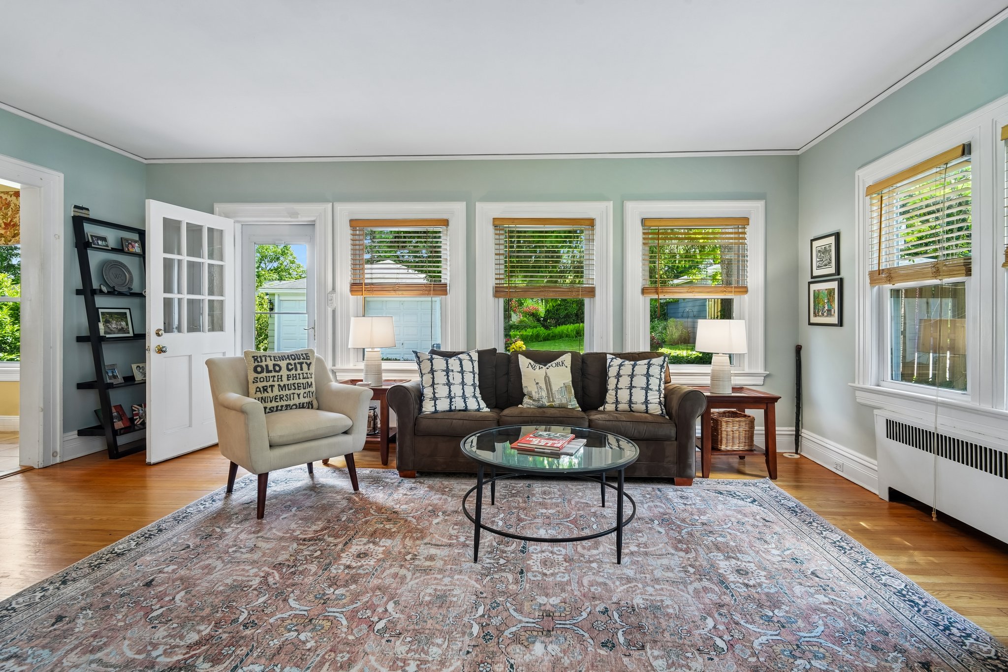 Wrapped in windows and overlooking the backyard, this inviting retreat offers a front-row seat to every season - from spring blooms to summer dinners under the trees.