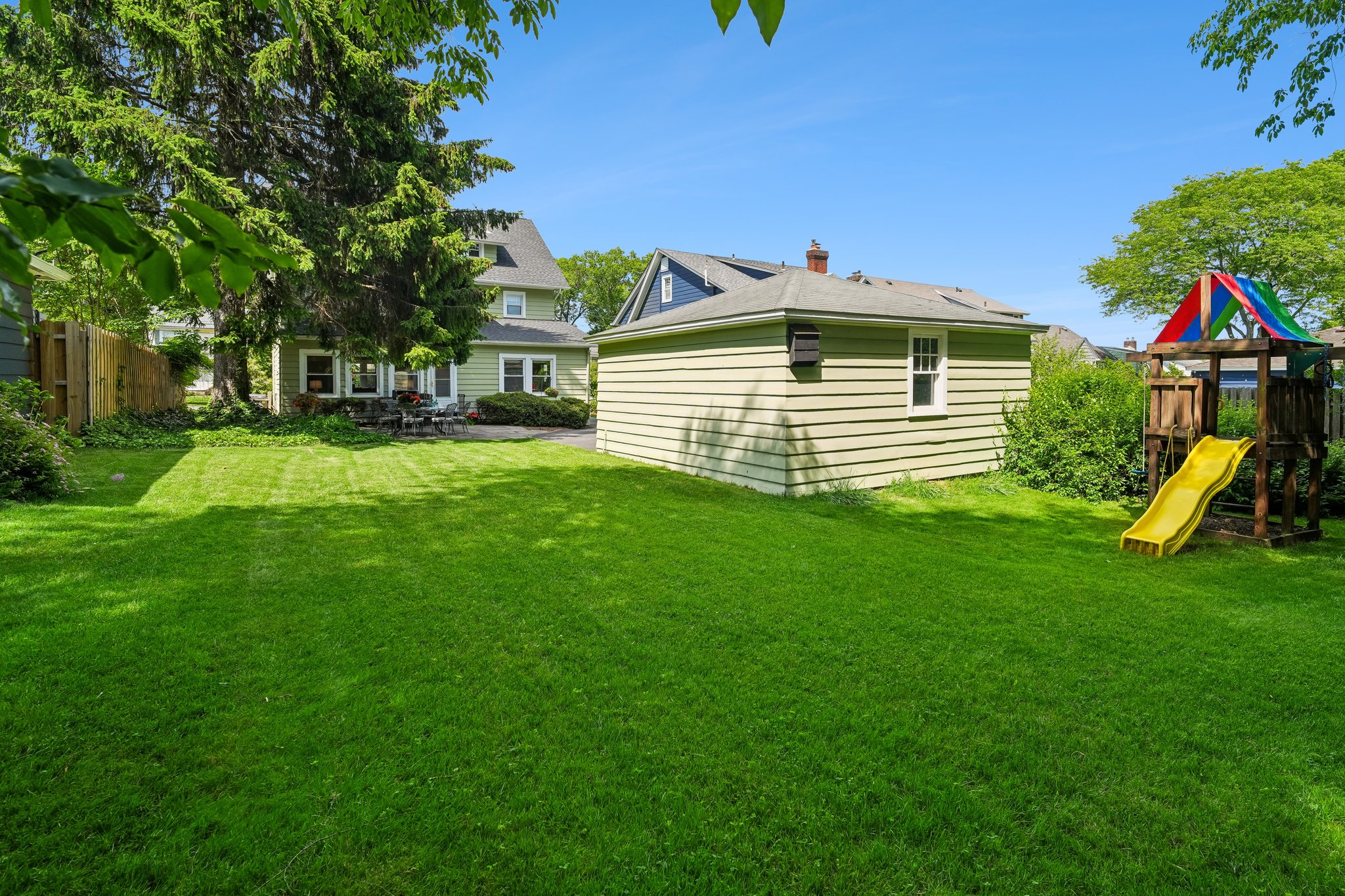 Expansive backyard with an extra play space behind the garage.  Swingset included with purchase!