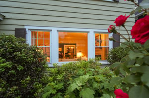 Through the roses, a glimpse of what awaits inside: warm rooms, welcoming light, and a home that has quietly nurtured generations. Some things never go out of style.