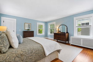 Soft natural light, peaceful views, and calming blue tones create the kind of bedroom that encourages slow mornings and early nights with a good book.