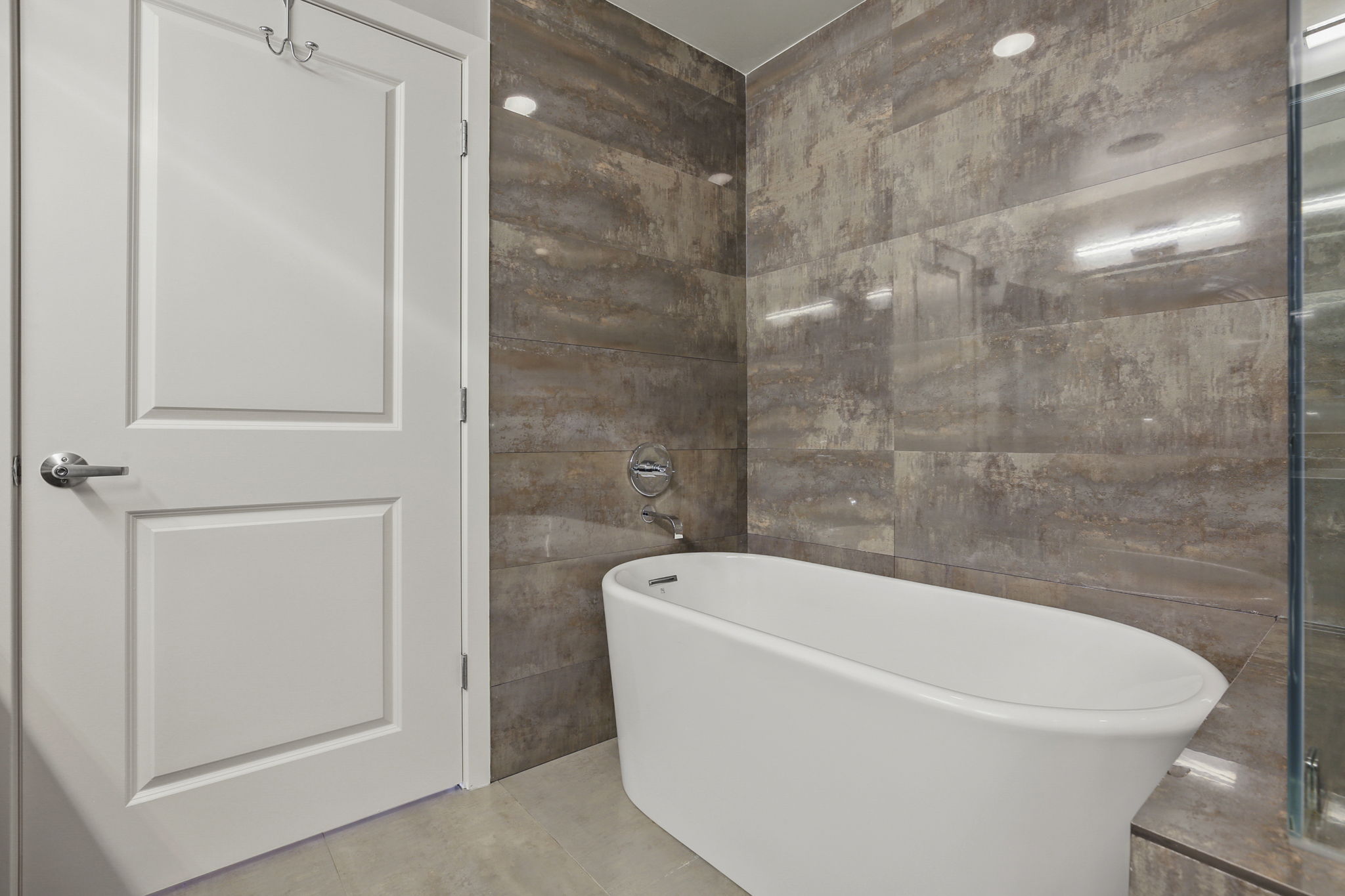 1912 Primary Bathroom •	American Standard high efficiency toilet (June 2022) •	Double Kohler vanity sinks •	Double Delta Shower •	UPC Bathtub •	Shower wall tiles – Porcelanosa Shine Dark glazed Quartz (13” x 40” tiles), Spain  •	Floor – Porcelanosa Ferroker Aluminio Quartz (17” x 26” tiles), Spain •	Heated Floor – Suntouch Programmable Floorstat