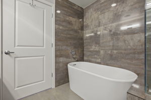 1912 Primary Bathroom •	American Standard high efficiency toilet (June 2022) •	Double Kohler vanity sinks •	Double Delta Shower •	UPC Bathtub •	Shower wall tiles – Porcelanosa Shine Dark glazed Quartz (13” x 40” tiles), Spain  •	Floor – Porcelanosa Ferroker Aluminio Quartz (17” x 26” tiles), Spain •	Heated Floor – Suntouch Programmable Floorstat
