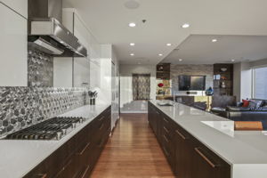 1901 Kitchen • Redstone Kitchen Cabinets, modern flat panel white poly gloss doors with polished nickel 12” square bar pulls, pantry sliders, drawer inserts (soft close doors & drawers) •	Dekton 2cm Glacier Countertops •	Porcelanosa Noohn Mosaic stainless steel backsplash tiles (metal hexagon), Spain