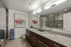1912 Primary Bathroom •	American Standard high efficiency toilet (June 2022) •	Double Kohler vanity sinks •	Double Delta Shower •	UPC Bathtub •	Shower wall tiles – Porcelanosa Shine Dark glazed Quartz (13” x 40” tiles), Spain  •	Floor – Porcelanosa Ferroker Aluminio Quartz (17” x 26” tiles), Spain •	Heated Floor – Suntouch Programmable Floorstat