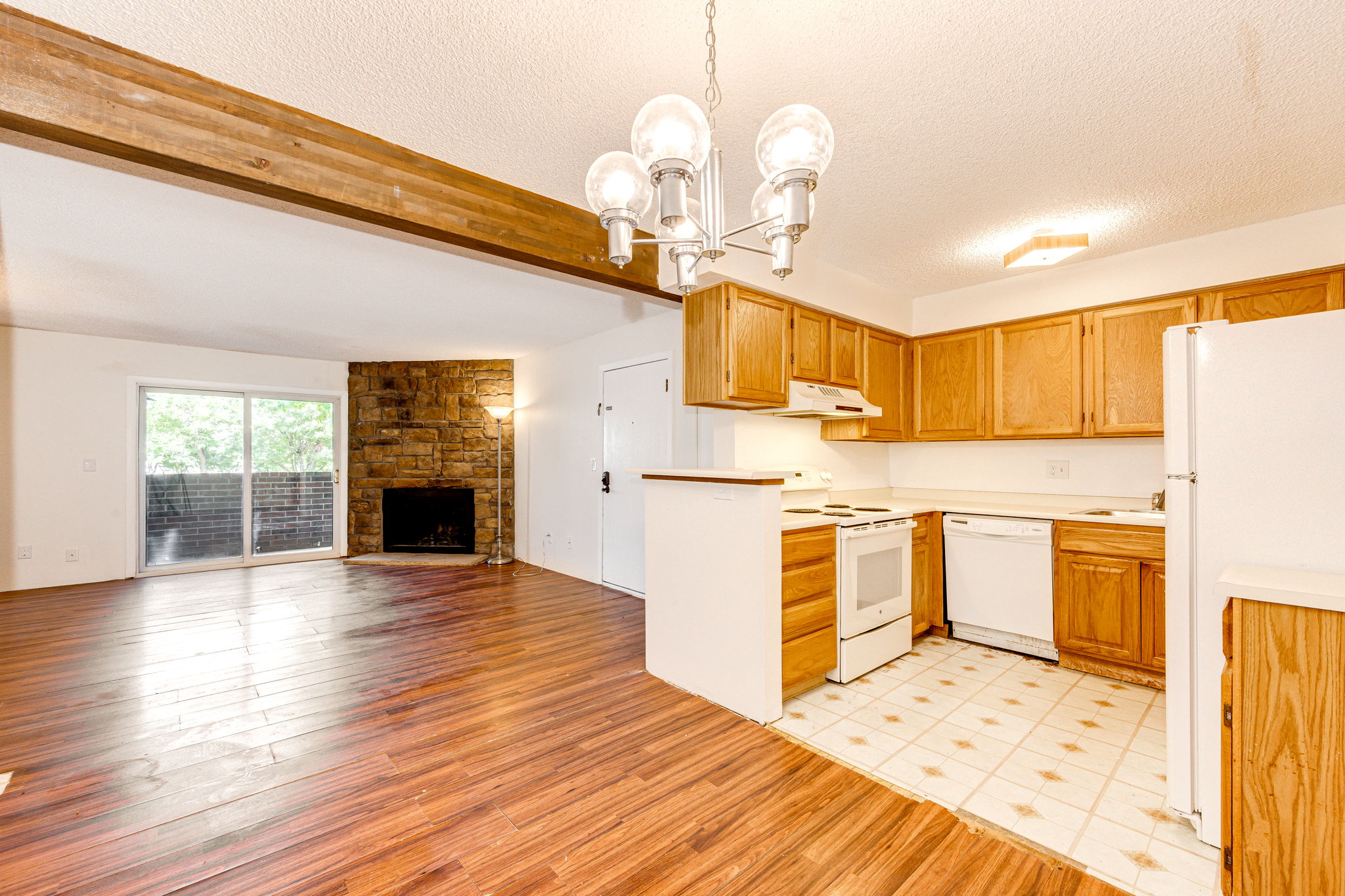 View of the kitchen, living room and patio doors leading out onto the patio area