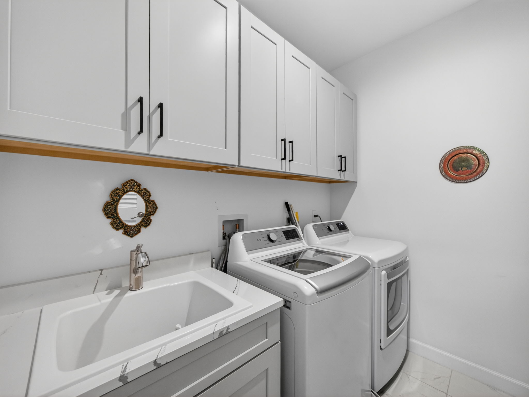 Laundry with added cabinetry and sink