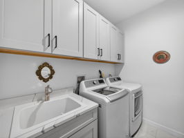 Laundry with added cabinetry and sink