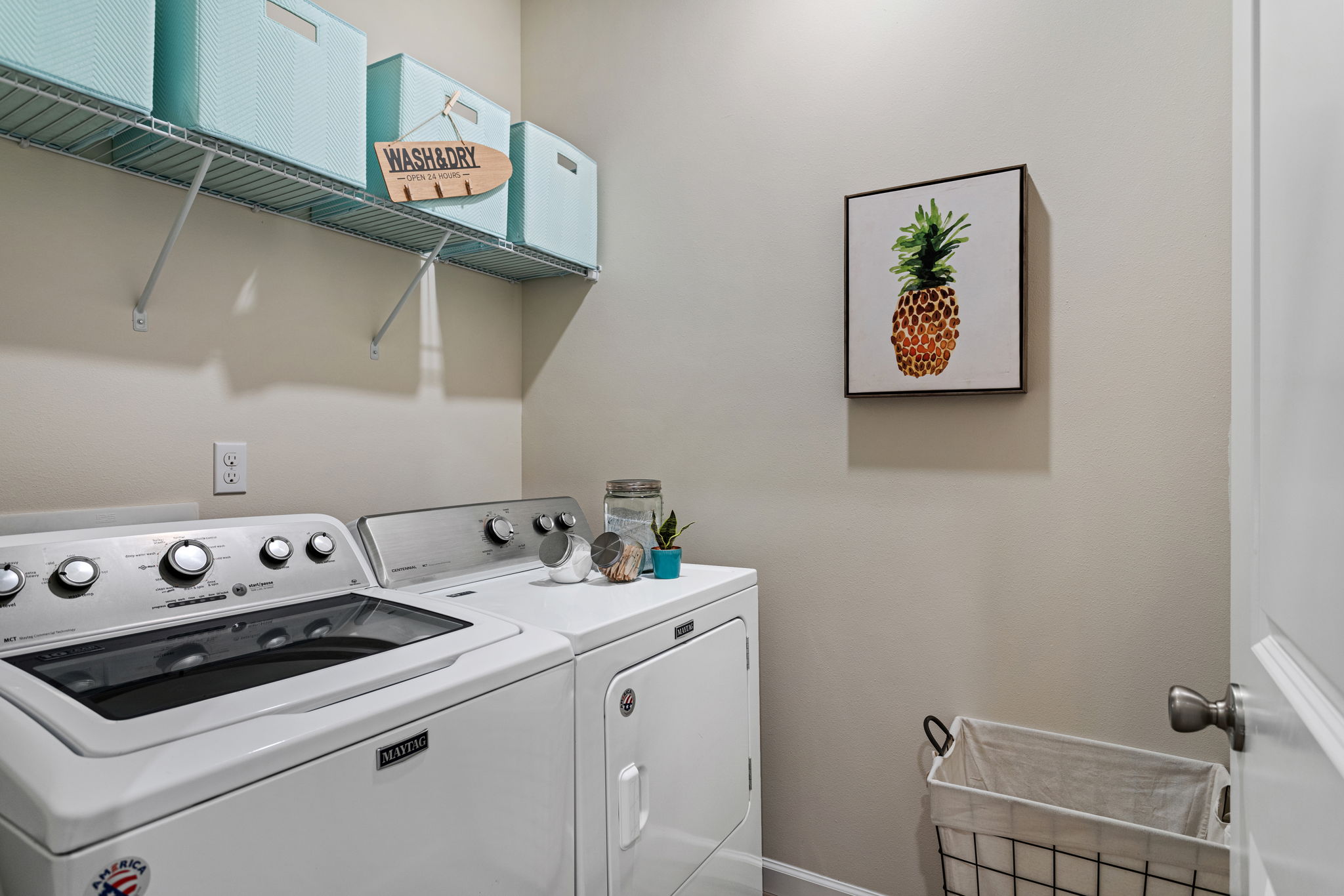 Spacious laundry room and shelving for all your laundry necessities!