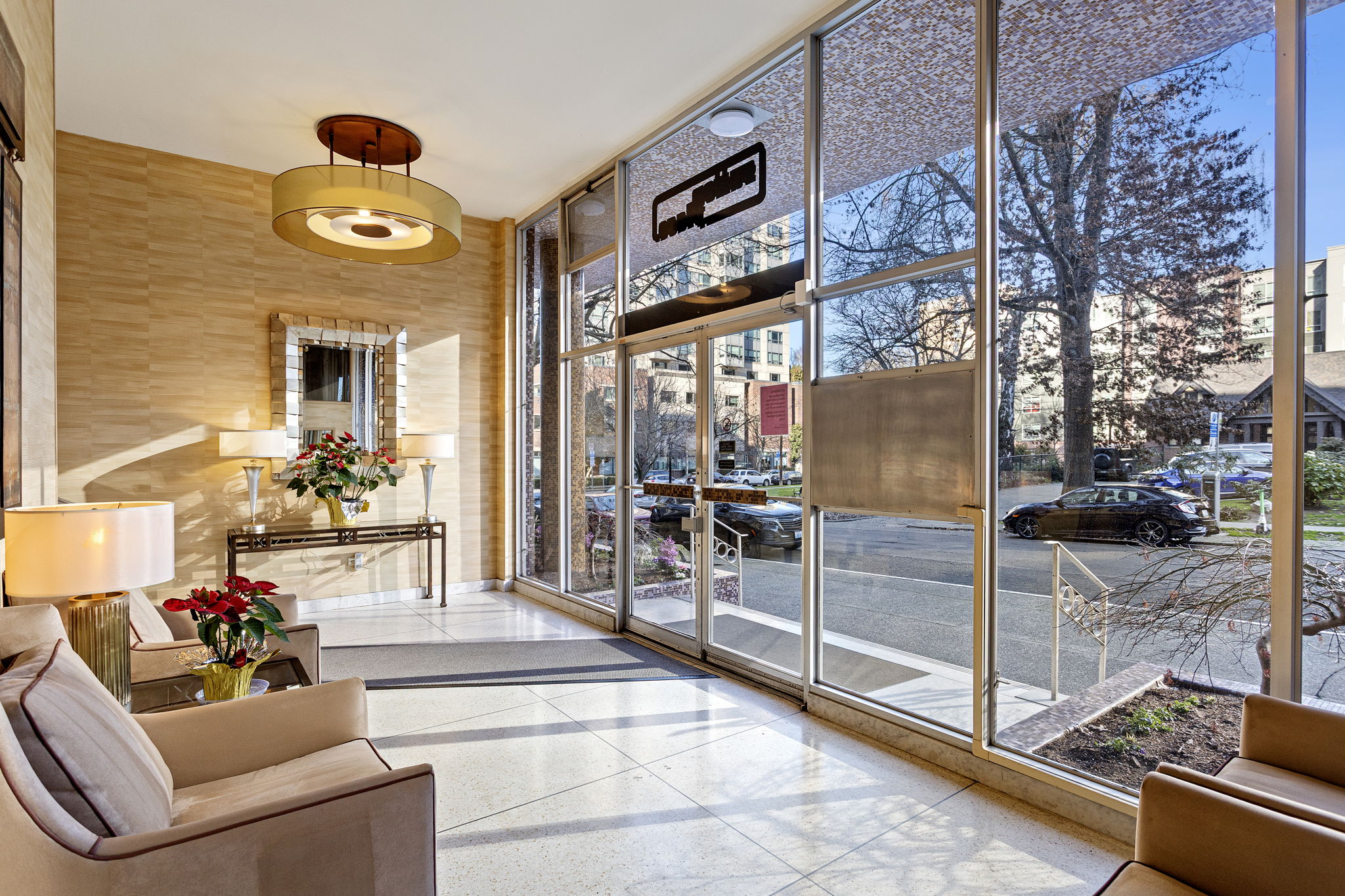 Morning light in the lobby, with classic mid-century lines and a calm, collected mood.