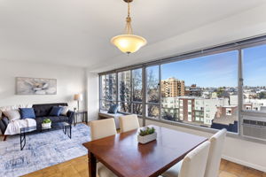 A true dining space wrapped in glass, with clear daylight and an open neighborhood outlook that keeps the room feeling connected.