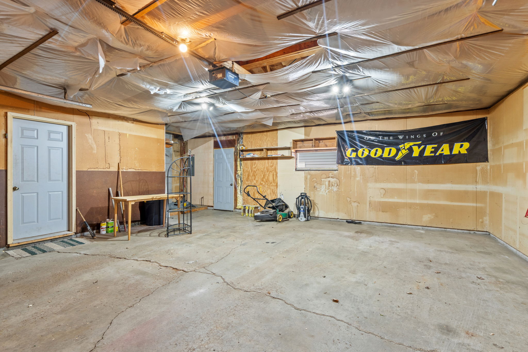 27x24 foot garage with extra workshop area in the back and rear man door to backyard and other detached garage