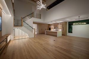 View 1 - Open living area designed for entertaining, enhanced with sleek low-voltage lighting throughout.