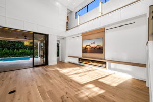 View 2 - Open living area overlooking the pool, highlighted by soaring 22’ ceilings and an airy, expansive feel.