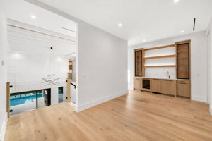 Guest loft featuring a wet bar and dishwasher for added comfort and convenience.