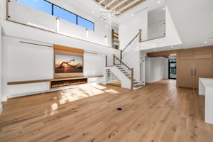 View 1 - Open living area overlooking the pool, highlighted by soaring 22’ ceilings and an airy, expansive feel.