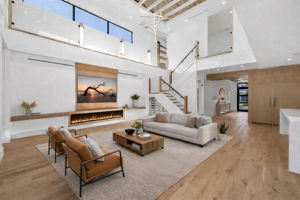 View 1 (virtually staged) - Open living area overlooking the pool, highlighted by soaring 22’ ceilings and an airy, expansive feel.