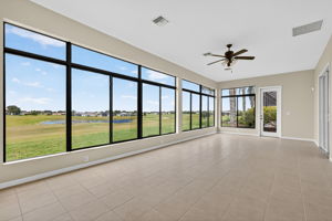 Immense Under-Air Enclosed Lanai with Golf and Water Views