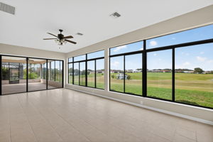 Immense Under-Air Enclosed Lanai with Golf and Water Views