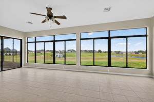Immense Under-Air Enclosed Lanai with Golf and Water Views