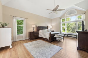 MAIN LEVEL PRIMARY BEDROOM BOASTS LARGE TRANSOM WINDOW