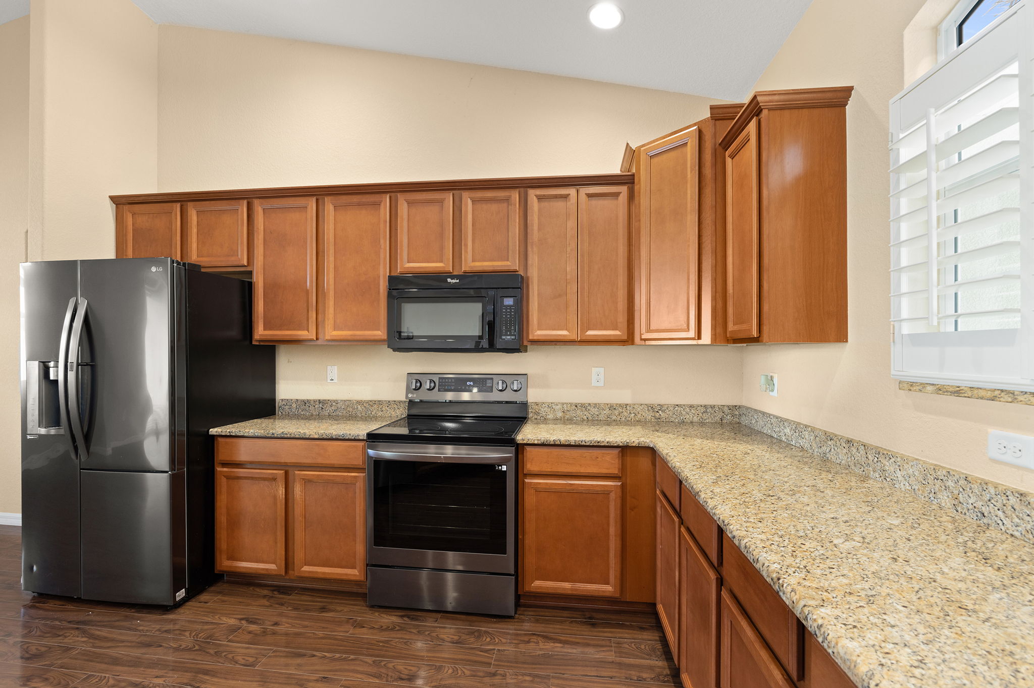 Kitchen With Great Storage, Granite Countertops, And Matching Black Appliances