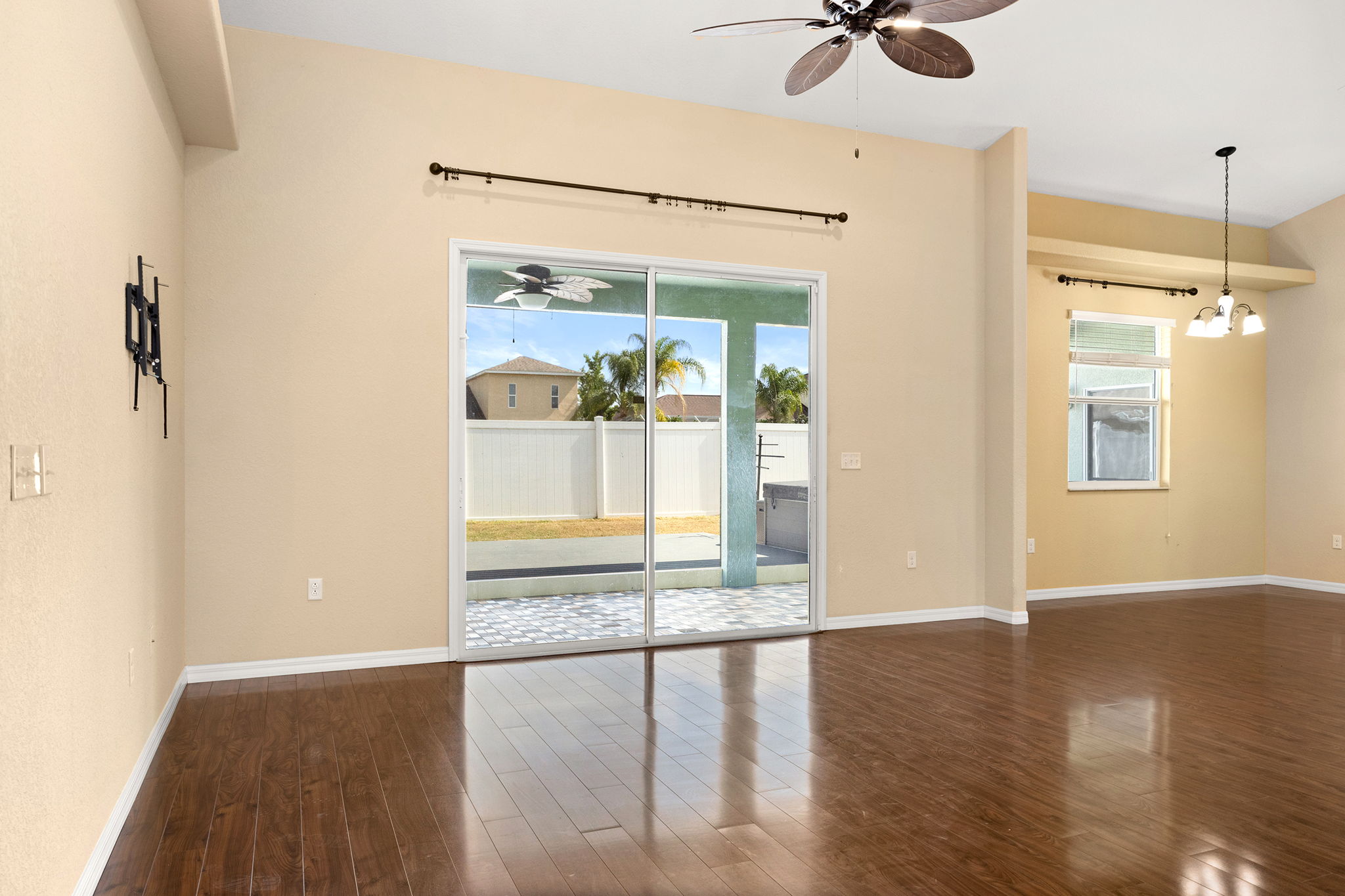 Living Area With Glass Doors To Covered Lanai & Back Yard; Also, Casual Dining Area On Right