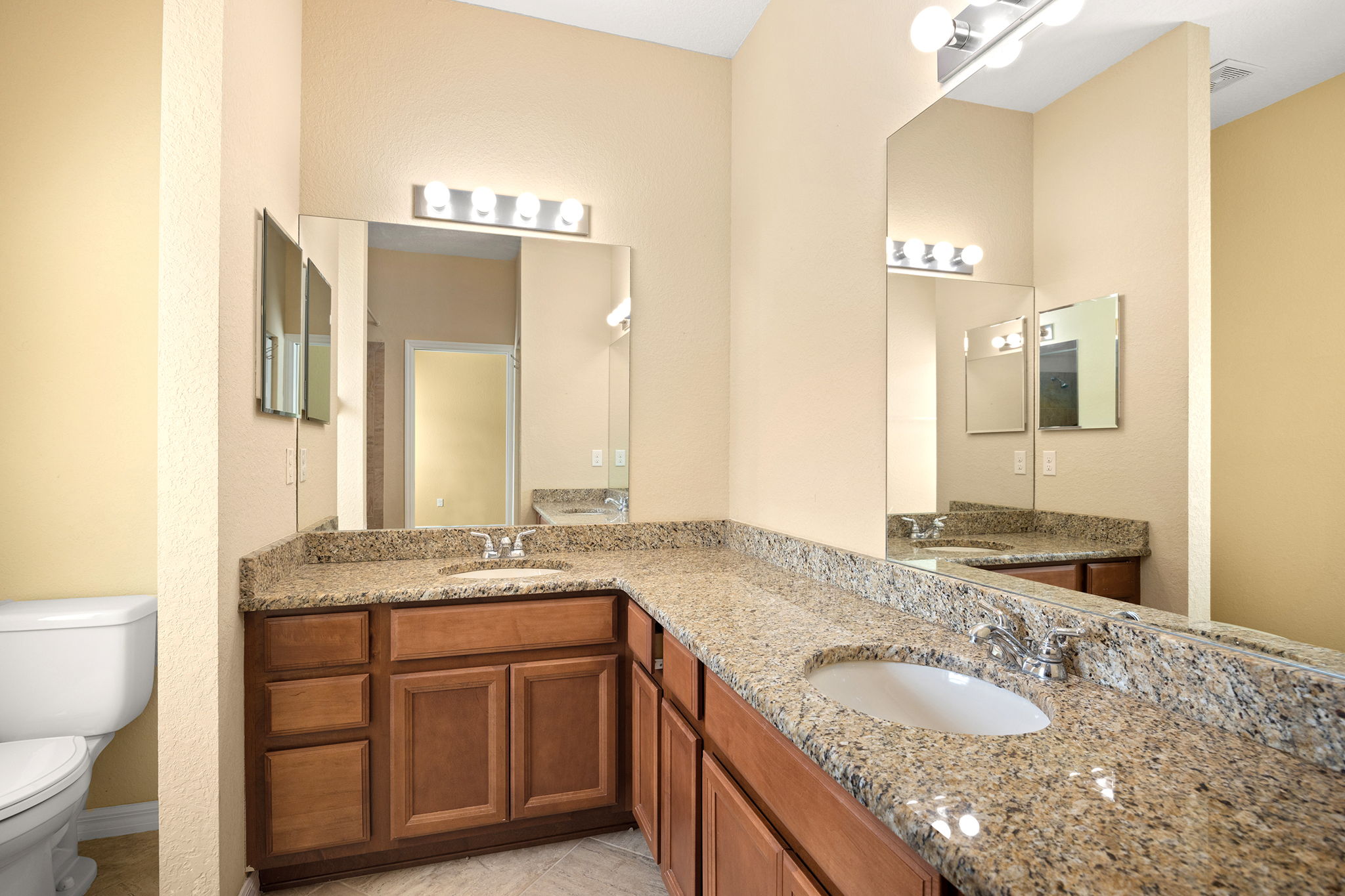 Primary Bathroom With Dual Sinks & Granite Countertops