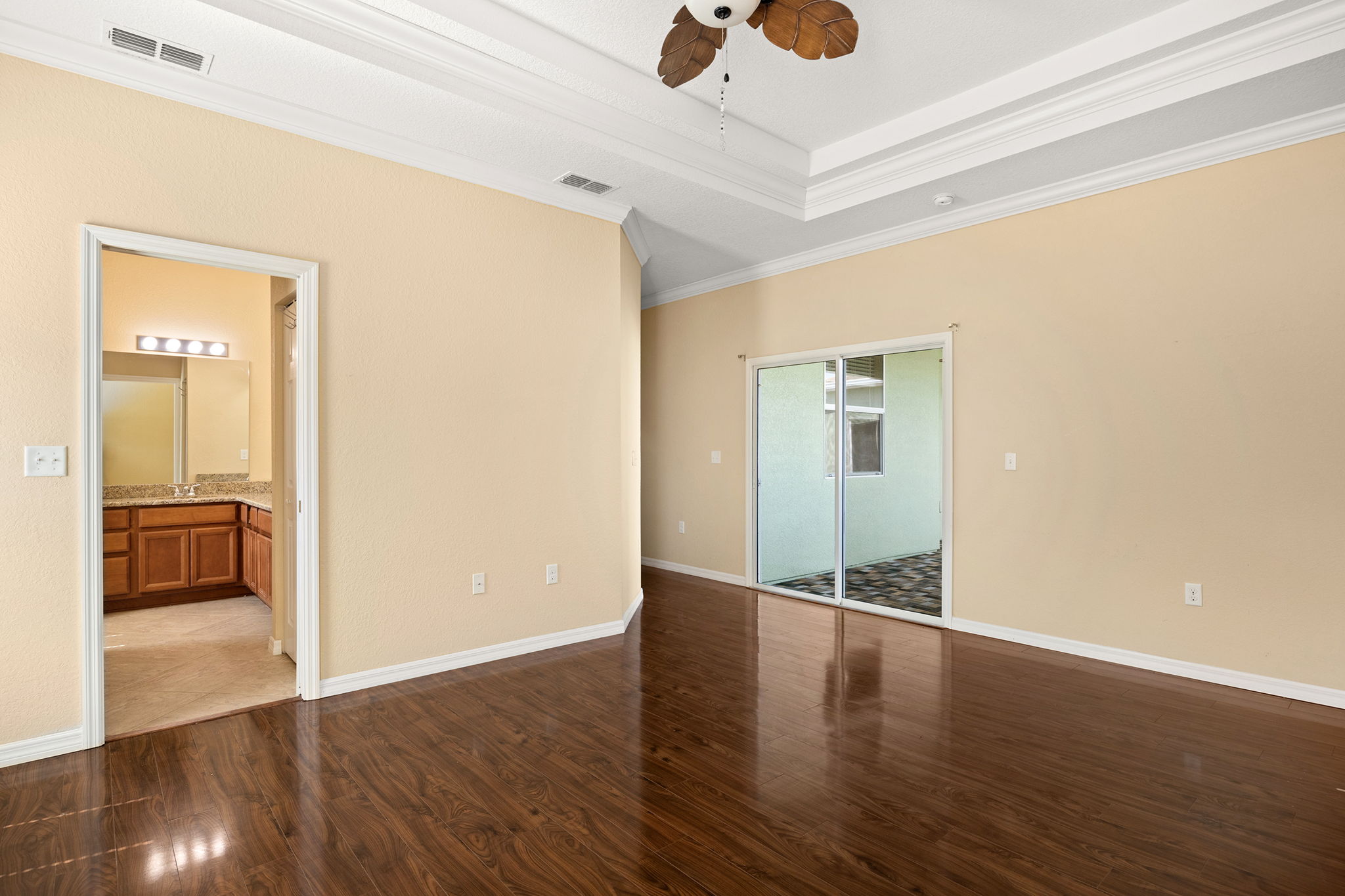 Primary Bedroom With Sliding Glass Door To Lanai; Door To Primary Bathroom; Note: Walk-in Closet In Hallway