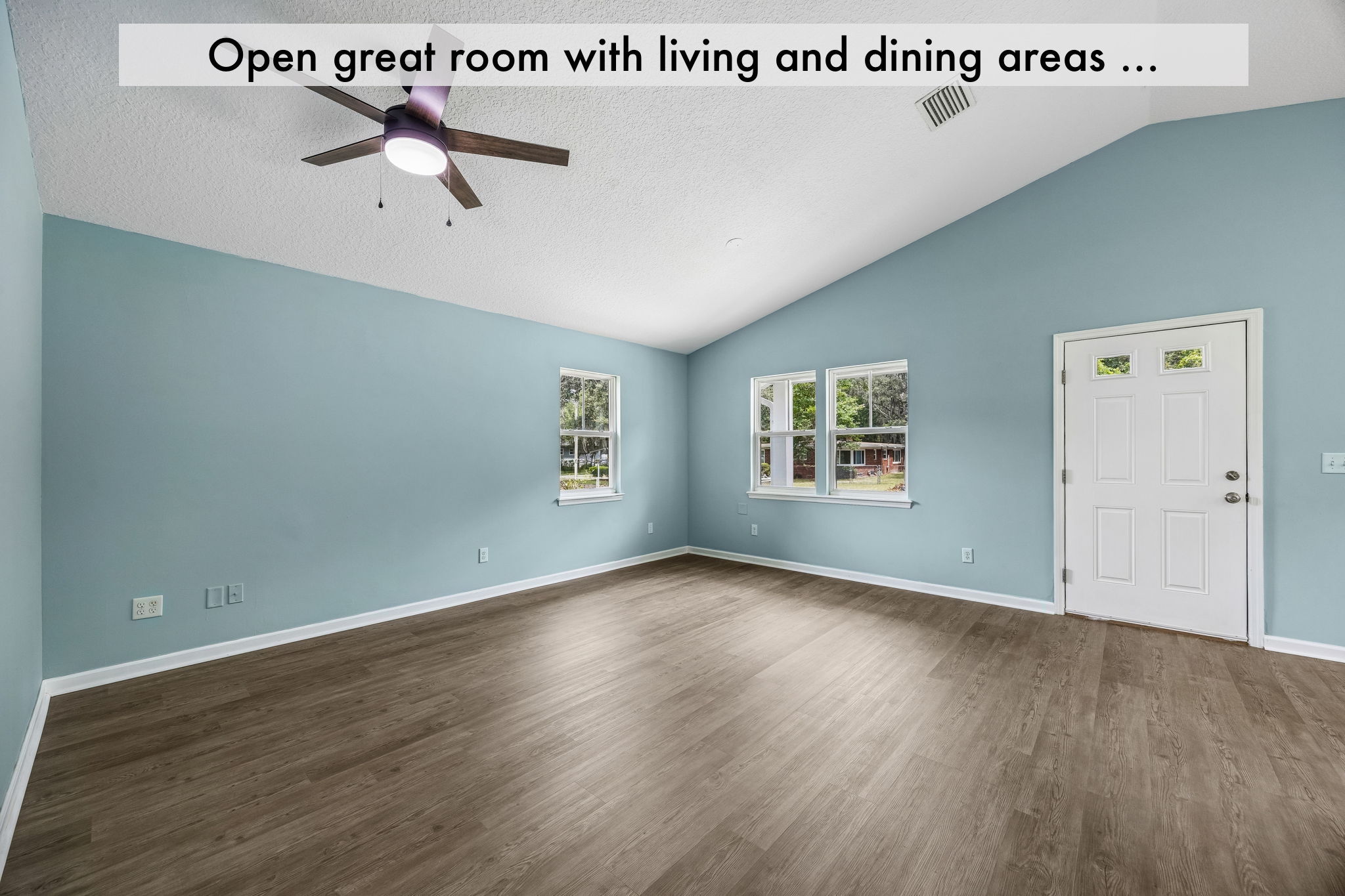 The vaulted great room brings living and dining together in one airy, flexible gathering space …