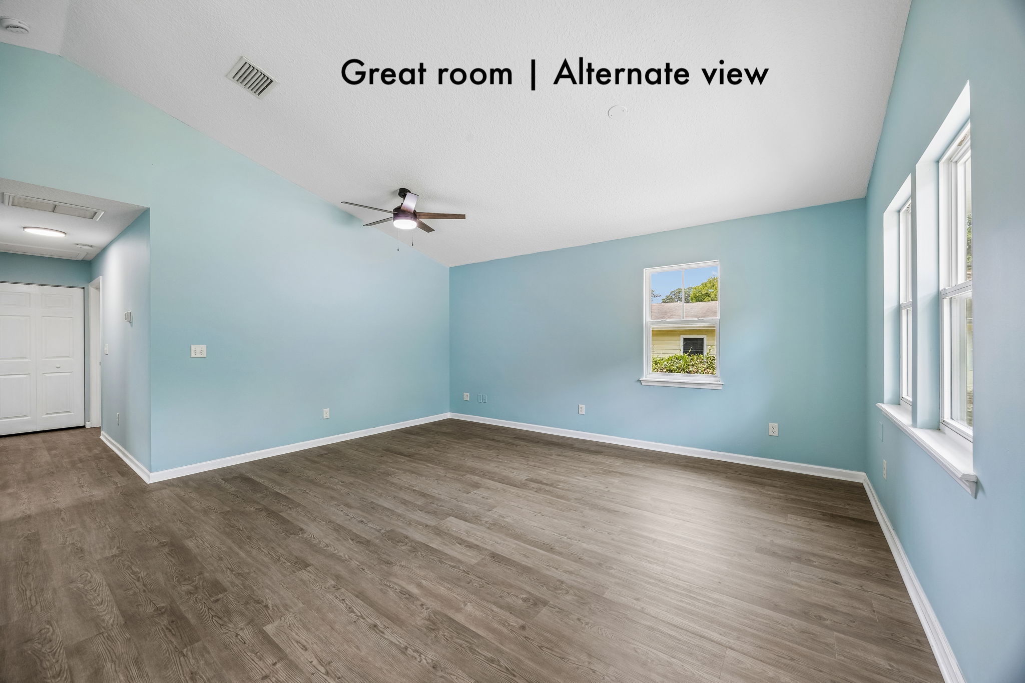 Multiple windows, vaulted ceilings and an open footprint gives the great room an inviting sense of space