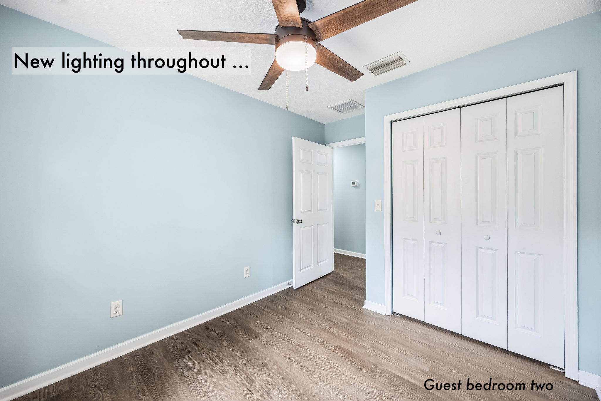 New lighting, a ceiling fan and a wide closet complete the flexible second guest bedroom