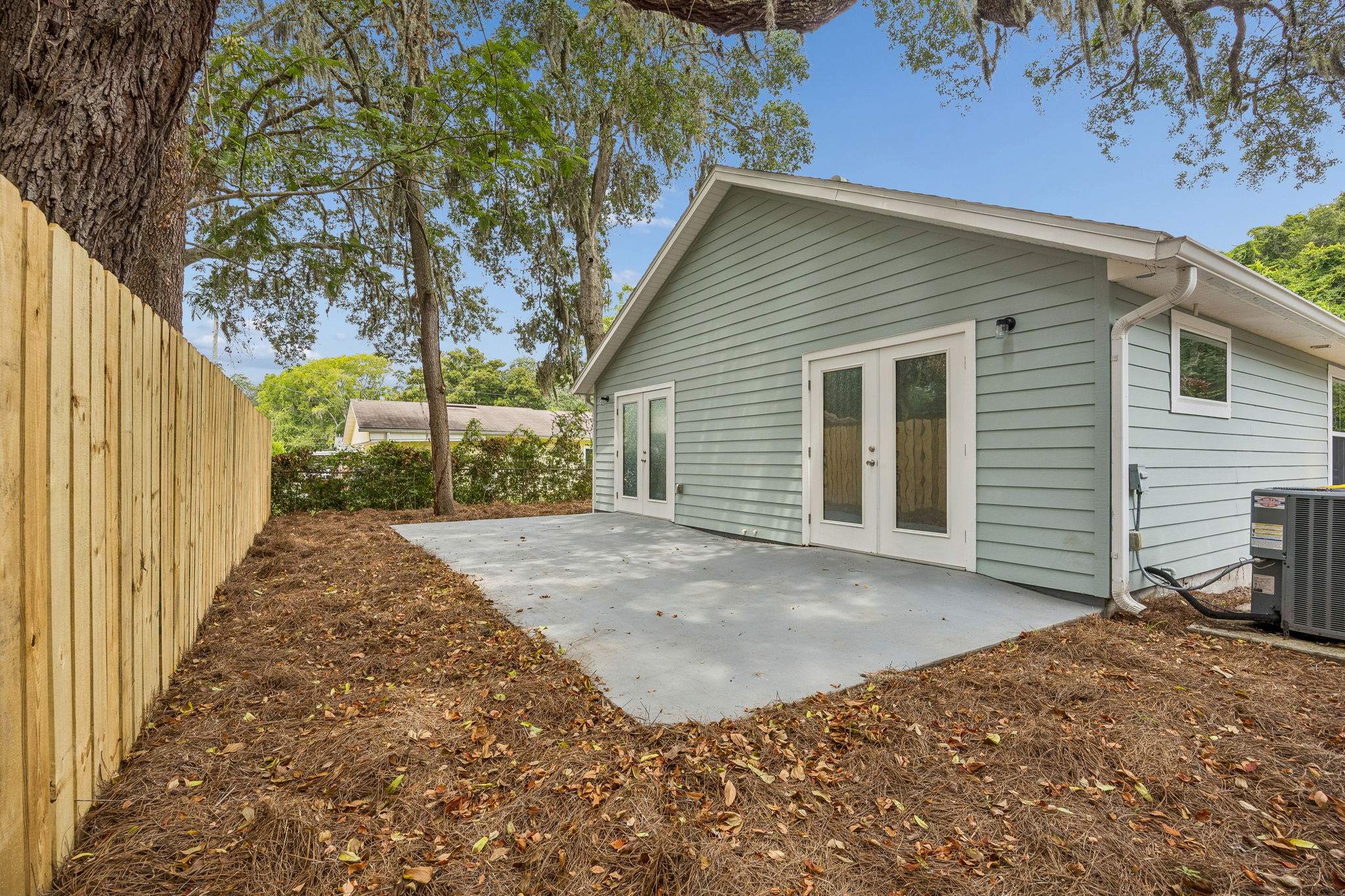The broad concrete patio offers flexible space for seating, grilling and easy outdoor entertaining