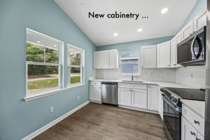 The renovated kitchen pairs crisp new cabinetry with abundant natural light and a practical, efficient layout ...