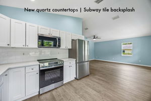 Quartz countertops and a classic subway tile backsplash bring a clean, timeless finish to the space