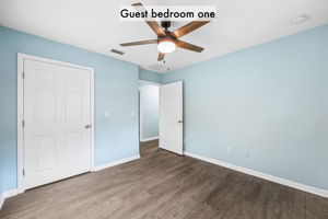 A ceiling fan, plank flooring and a full closet make this a practical and inviting guest retreat …