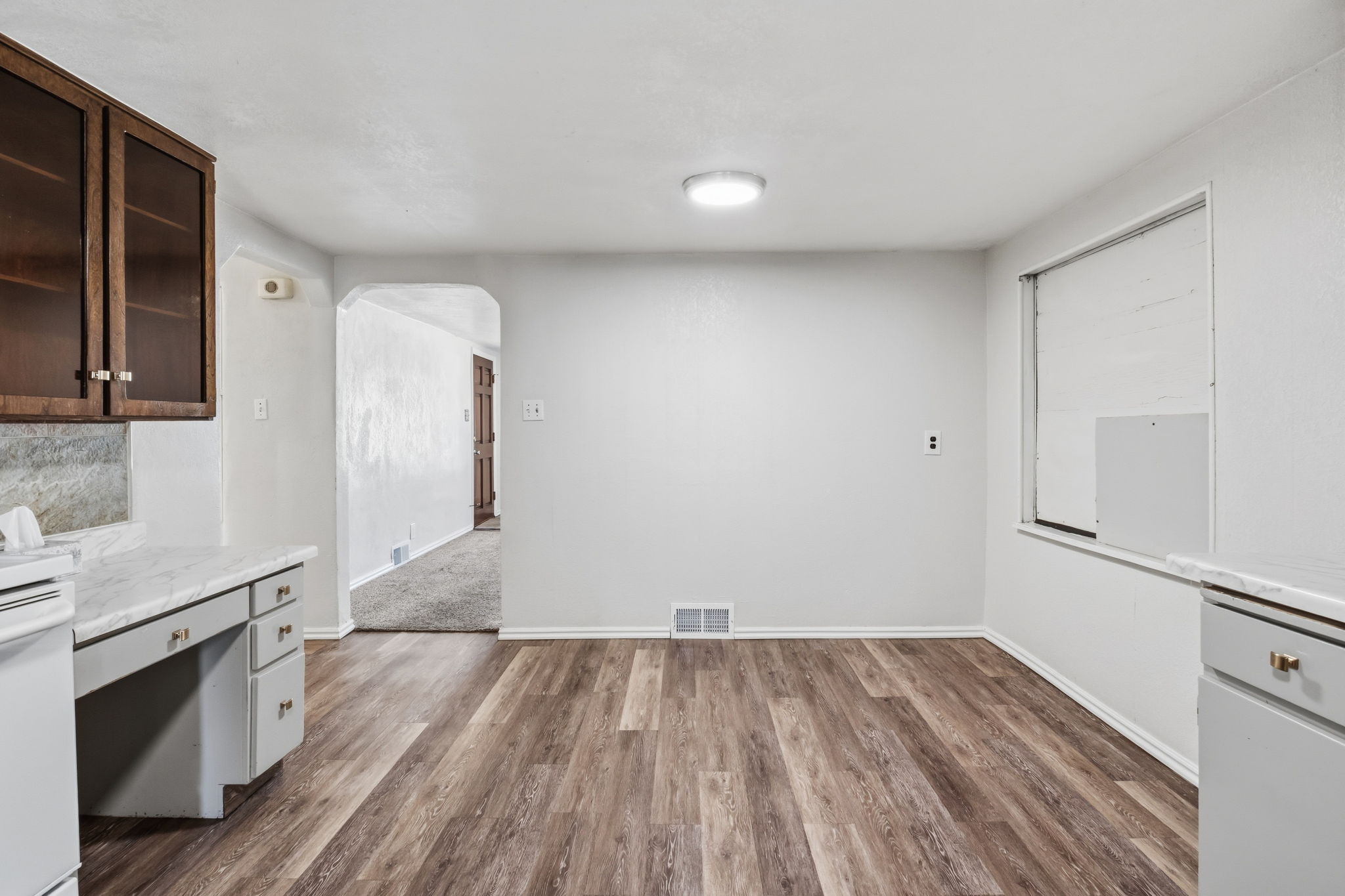 dining space, boarded up window, desk