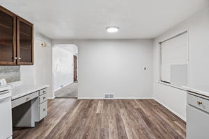 dining space, boarded up window, desk
