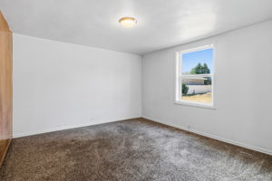 bedroom with 1 paneled wall