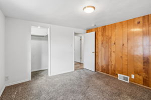 closet, paneled wall in bedroom
